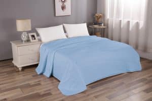 bed with blue quilt cover